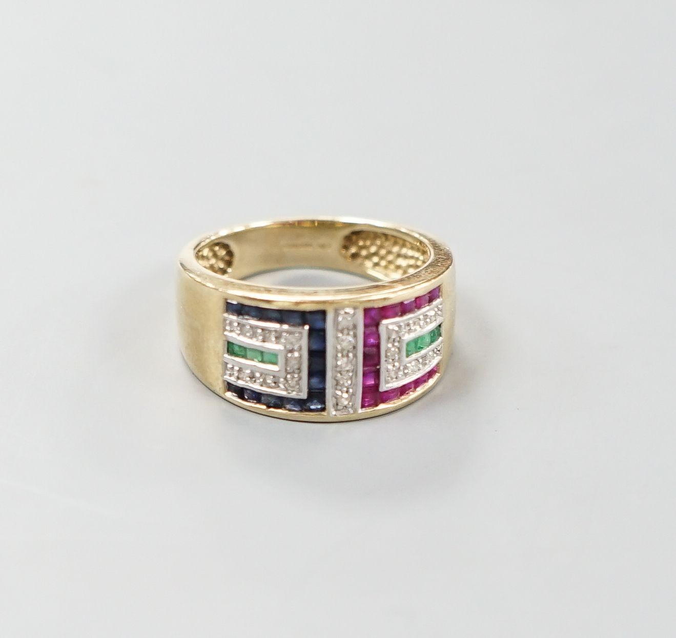 A modern 9ct gold, emerald, ruby, sapphire and diamond set geometric dress ring, size Q, gross weight 5.3 grams.